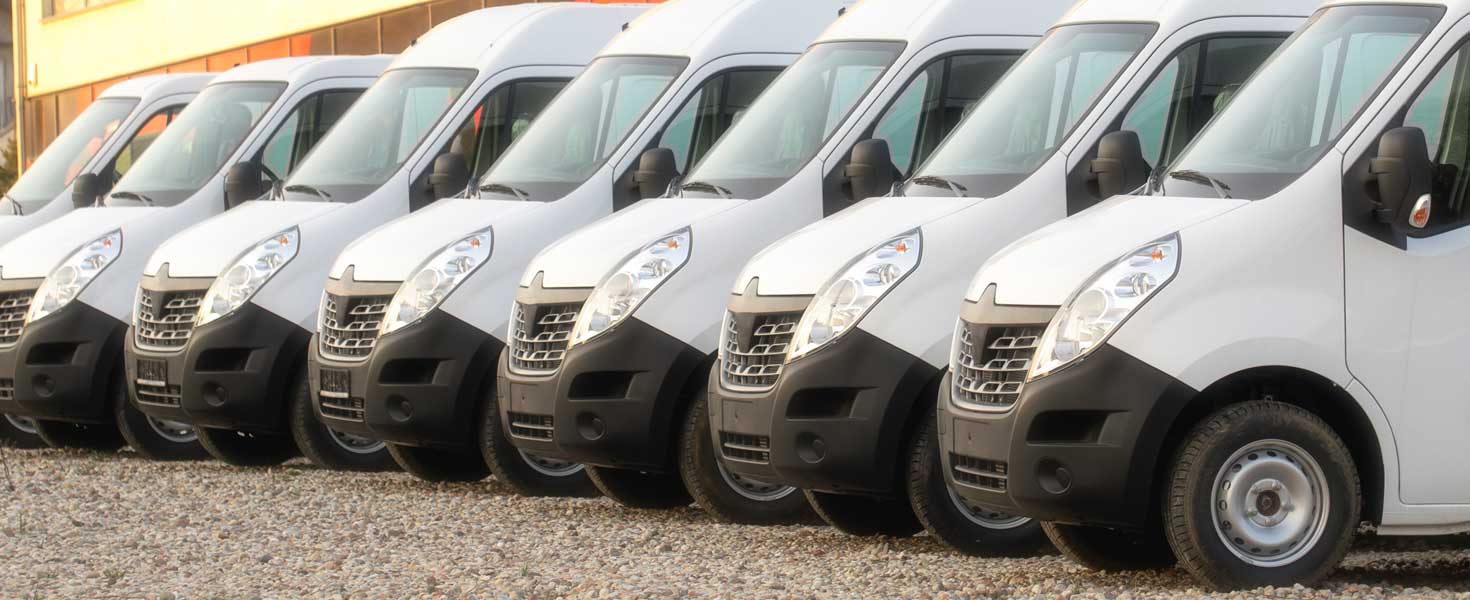 Commercial vehicle vans parked in a row.